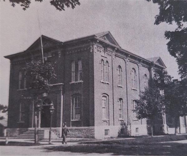 A black and white photo of an old school building.