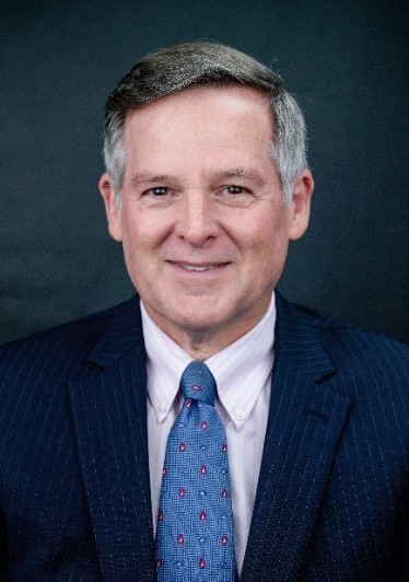 A photo of Stephen O'Dowd in a suit and tie.